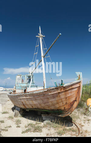 An old Greek wooden fishing boat is decaying in a dry dock at Astrakeri, Corfu Stock Photo