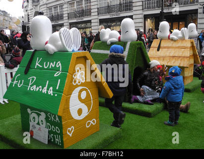 London, UK. 28th Nov, 2015. The dog houses 'Panda's Palace' (L-R) designed by US actor Jack Black, 'The Wimbledog' by tennis player Andy Murray and 'Snoopy Snaps' by fashion photographer Rankin on display prior to the theatrical release of 'The Peanuts Movie' in London, England, 28 November 2015. About a dozen of the colourful houses are to be auctioned off through the internet, with the proceeds to be donated to relief organisations. Photo: TERESA DAPP/dpa/Alamy Live News