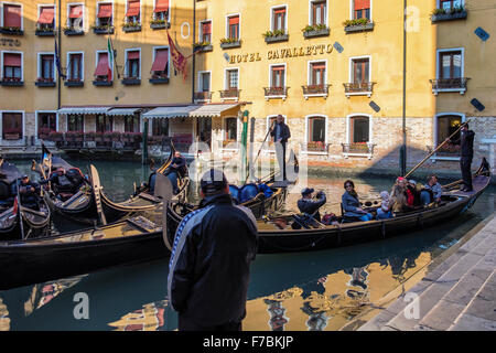 Venice, Italy - Hotel Cavalletto and Gondoliers waiting for passengers in Gondolas Stock Photo