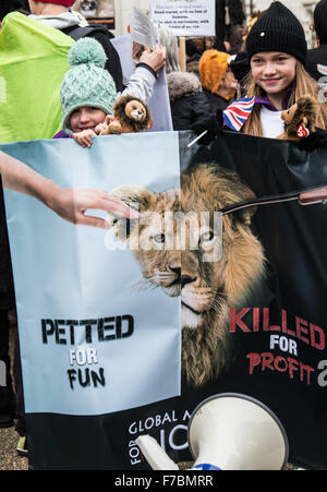 London, UK. 28th November, 2015. two girls holding poster with Lions in March for Lions at Bomber Command Memorial. Stock Photo