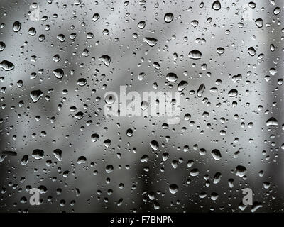 Static stark raindrops on a window pane with monochrome background Stock Photo