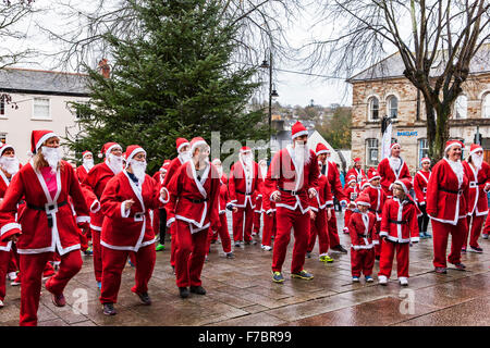 Bodmin Santa Fun Run. Bodmin, Cornwall, England. 28th November 2015. Bodmin Santa Fun Run organised by the Charity, Cornwall Hospice Care. The Santa’s, Runners, getting into the spirit of Christmas. Credit:  Barry Bateman / Alamy Live News Stock Photo