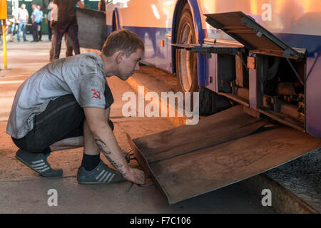 Man Repairing Trolleybus, Repair Shop, Trolleybus Depot, Chisinau Stock Photo