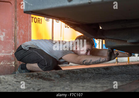 Man Repairing Trolleybus, Repair Shop, Trolleybus Depot, Chisinau Stock Photo