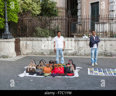 Fake Prada and designer handbags on sale at the Spanish Steps, Rome Italy Stock Photo