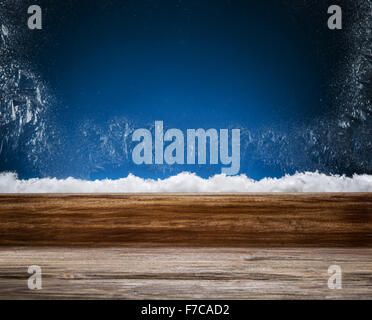 Winter window with frost patterns in the night. Focus on the windowsill. Stock Photo