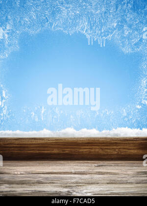 Winter window with frost patterns in the day. Focus on the windowsill. Stock Photo