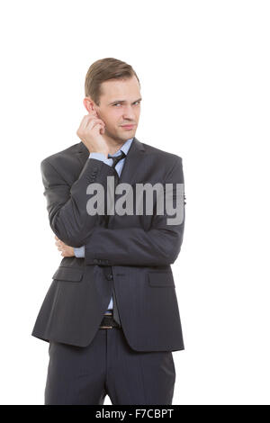 body language. man in business suit isolated white background. scratching, rubbing the ear. gesture of distrust speaker Stock Photo