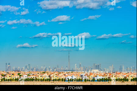 Skyline of Dubai with modern luxury villas at The Villa residential housing development in foreground in United Arab Emirates Stock Photo