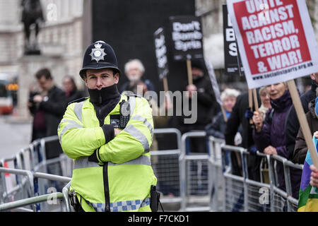 A Metropolitan Police Officer on duty as protesters gather opposite Downing Street in London to protest at the UK government pro Stock Photo