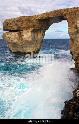 (151129) -- VALLETTA, Nov. 29, 2015 (Xinhua) -- Photo taken on Nov. 28, 2015, in Gozo, Malta shows the view of the Azure Window. The Azure Window, Malta's famous natural landscape, is located in its second largest island Gozo. The Azure Window is one of the most photographed vistas of Malta, and is particularly spectacular during the winter, when waves crash high inside the arch. At the end of the cliff, the Azure Window is a giant doorway, through which one can admire the water expanse beyond the cliff. The sea around is very deep and of a dark blue hue, which explains why it is called the Az Stock Photo