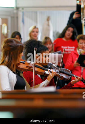 Two young women playing violin in a rehearsal Stock Photo