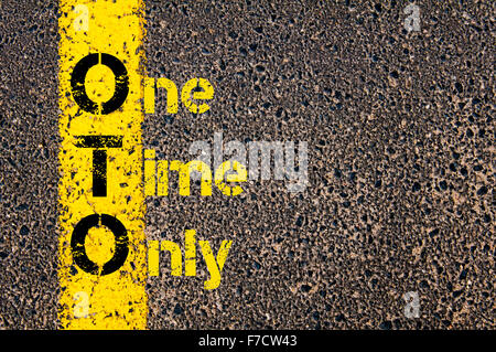 Concept image of Accounting Business Acronym OTO One Time Only written over road marking yellow paint line. Stock Photo