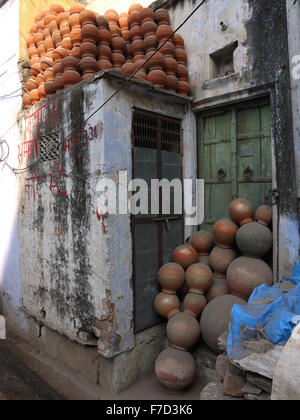 Street Scene - A collection of terracotta pots stacked up against a doorway and on top of another . Stock Photo