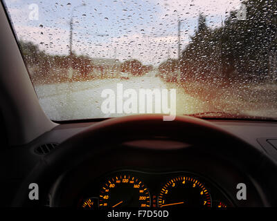 dashboard and rain droplets on car windshield Stock Photo
