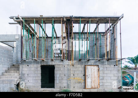 Scaffolding poles hold up shuttering for a concrete roof to be poured in a building site Stock Photo