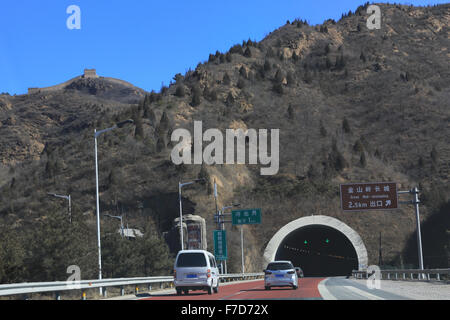 Road tunnel entrance and signage for the exit to the Great Wall of China at Jinshanling.