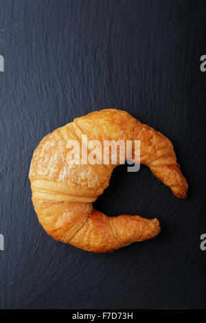 fresh croissant on slate, top view Stock Photo