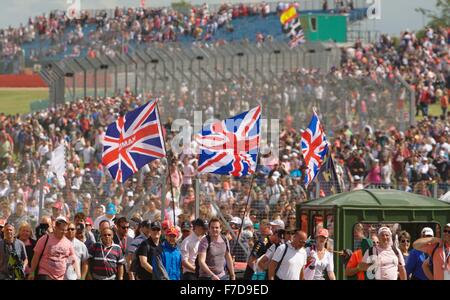 British fans invade the circuit to celebrate Lewis Hamilton's victory at the 2014 British F1 Grand Prix at Silverstone. Stock Photo