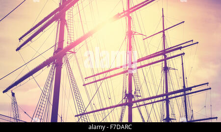 Retro vintage toned sailing masts at sunset, travel concept. Stock Photo