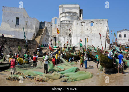 Fishing boats on beach below Cape Coast Castle, Cape Coast, Ghana Stock Photo