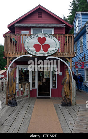 Tourist enjoy a visit to the boardwalk on Creek Street.  Gold and souvenir shops reside in remodeled houses of prostitution. Stock Photo