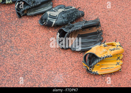 baseball gloves on a rubber background Stock Photo