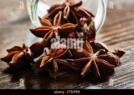 Star anise, glass jar of dark wood table Stock Photo