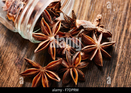 Star anise, glass jar of dark wood table Stock Photo