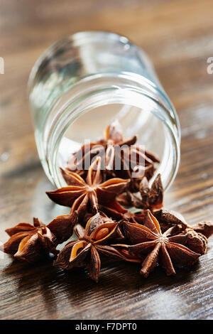 Star anise, glass jar of dark wood table Stock Photo