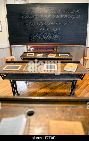 Old one room schoolhouse interior with desks and blackboard Stock Photo