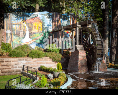 The Waterwheel and the mural, First Chemainus Sawmill 1862 (by Sylvia Verity Dewar) at Waterwheel Park, Chemainus, Canada. Stock Photo