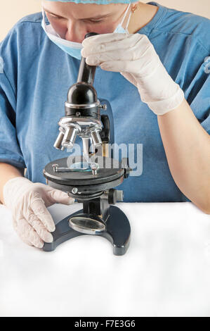 Attractive female scientist looking at the microscope slide in laboratory Stock Photo