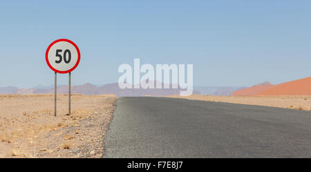 Speed limit sign at a desert road in Namibia, speed limit of 50 kph or mph Stock Photo