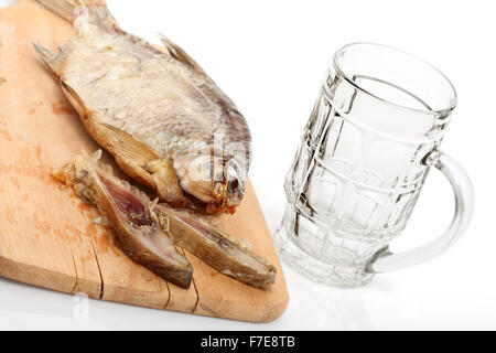 Sun Dried Bream and Empty Beer Mug. Isolated with clipping path. Stock Photo