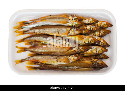 Golden  smoke-dried  fish in the plastic  plate. Isolated on white Stock Photo