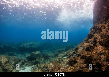 Divers explore natural caves and rocks in the Mediterranean sea off the coast of Larnaca, Cyprus, Stock Photo