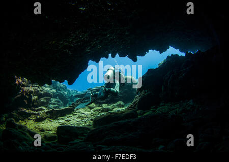 Divers explore natural caves and rocks in the Mediterranean sea off the coast of Larnaca, Cyprus, Stock Photo