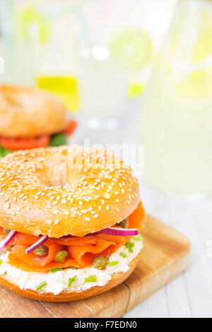 A bagel with salmon, cream cheese and capers. Photographed in bright light with a shallow depth of field. Stock Photo