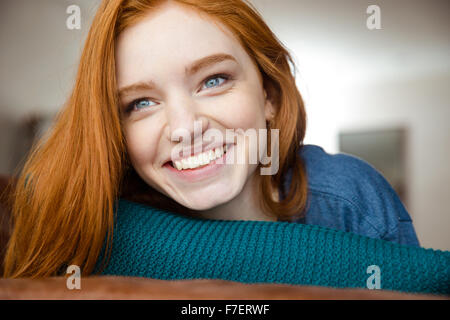 Closeup of positive beautiful happy young redhead woman  smiling and looking away Stock Photo