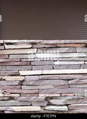 Loose tiled wall in grey stone with a copyspace background Stock Photo