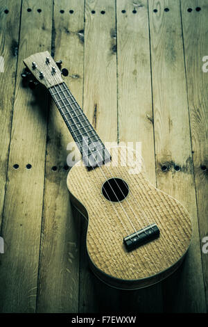 Ukulele on a wooden floor. Stock Photo