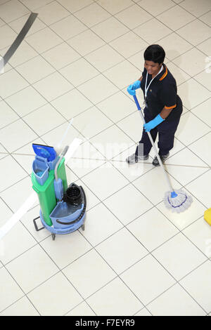 A hospital cleaner mops the floor in a modern UK hospital. Viewed from above. Stock Photo