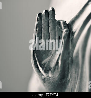 detail of a representation of the buddha with his hand in gyan mudra in duotone Stock Photo