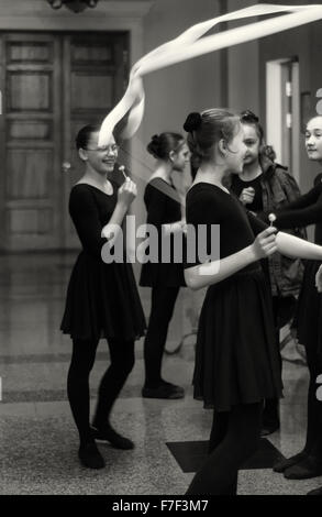 Young Russian Ballerinas eat lollipops and joke as they prepare for a Ballet dance class in a local UNESCO sponsored school.  Th Stock Photo