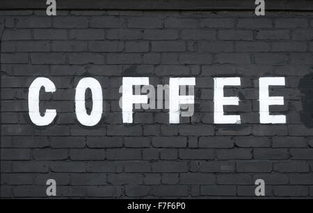 white coffee word painted on black brick wall Stock Photo