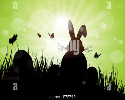 Silhouette of the Easter bunny sat in the grass Stock Photo