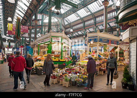 People shoppers shopping at Leeds Kirkgate indoor Market Leeds city centre West Yorkshire England UK United Kingdom GB Great Britain Stock Photo