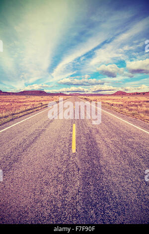 Retro stylized desert highway, travel adventure concept, USA. Stock Photo