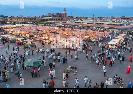 Dusk view of food stalls and crowds in Jemaa El Fna Square in Marrakech, Morocco.